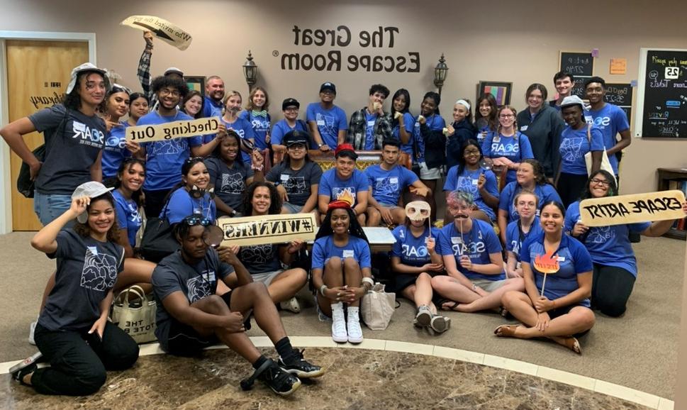 group picture of students in the lobby of an escape room center